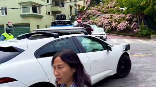 Waymo Google driverless car navigating the hilly left turn at Crooked street intersection, SFO, CA