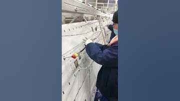 Electrical tape wrapping machine protecting and bundling wire harnesses