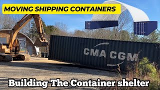 Moving full shipping containers around with a Trackhoe Excavator.  Building the container shelter
