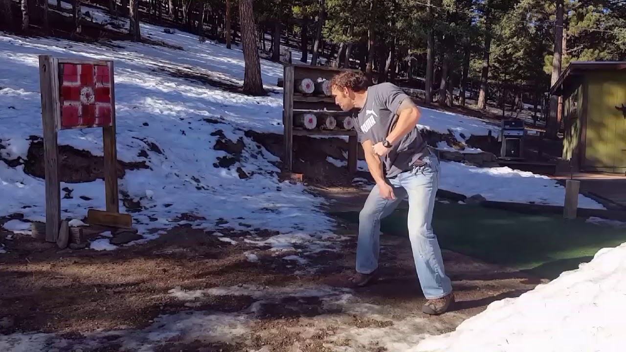 Practicing throwing knives from the hip, full spin