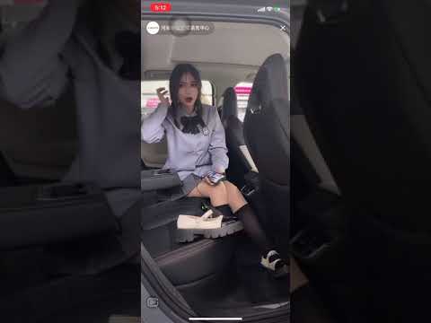 Chinese girl shoe off with her black nylon socks in car