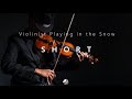 Short version  violinist playing in the snow