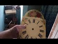 Discussing antique wooden plate shield clocks