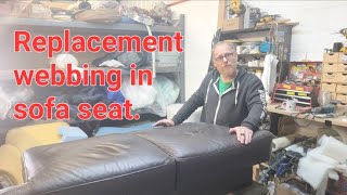 Replacement elastic webbing in leather sofa seat.