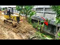 Small bulldozer working filling down the wall with 5t25t dump truck loading soil