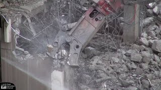 Closeups of demolition excavator munching on a concrete building (Episode 3 of 3)