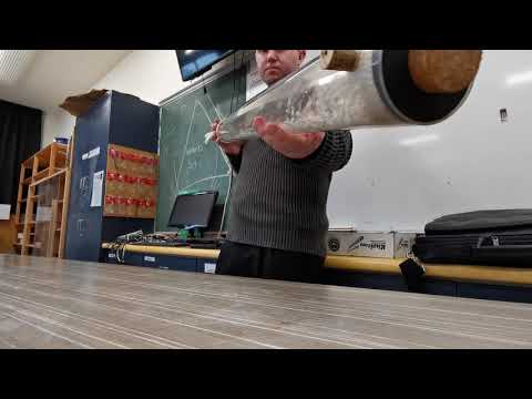 Shaking pipe full of polystyrene balls to show the propagation of sound ...