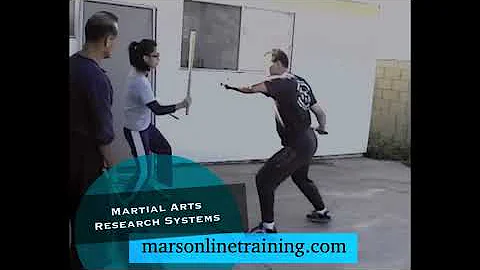 Diana Lee Inosanto and Ron Balicki taking a lesson from Dan Inosanto 2004.