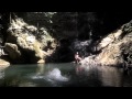 Jacqueline swings into pool under waterfall.