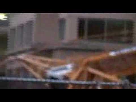 Are you a first responder? Check out ActionVids.blogspot.com On November 16, 2006 at 7 PM, a 210 ft construction crane collapsed killing one person, significantly damaging three buildings, and blocking 108th Avenue NE in downtown Bellevue, WA (in King County). The operator, Warren Taylor Yeakey, was in the crane when it fell and suffered minor injuries. Details: the crane was being used to construct a high-rise complex, called Tower 333, at NE 4th Street and 108th Avenue NE. With a loud snap, the crane fell southeast landing its middle on the east side of Plaza 305, making the office building partially collapse, though no one in it was injured. The crane's weight (back) end also ripped into the north side of the Civica Office Commons without injuring anyone. However, the tip of the crane's arm came down onto the Pinnacle Bell Centre Apartments killing Matthew Ammon on the top-fourth floor and exposing the interior of the second and third. The end result was the crane's arm being perpendicular and laying across 108th Avenue NE. Cracks at the base of the crane caused by frozen water are likely to blame for this accident. (My description is independent and sometimes different from that of early news reports). Note: video was shot on November 17, 2006. The high angle is shot from a little above the 30th floor of the One Lincoln Tower, northwest of the crane accident. News Reports: seattlepi.nwsource.com www.kirotv.com www.king5.com seattletimes.nwsource.com seattlepi.nwsource <b>...</b>