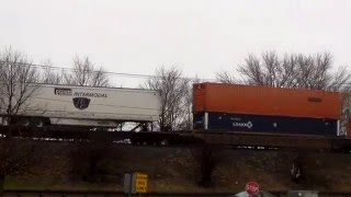 Fast CSX Van Train Westbound on Elevated Tracks