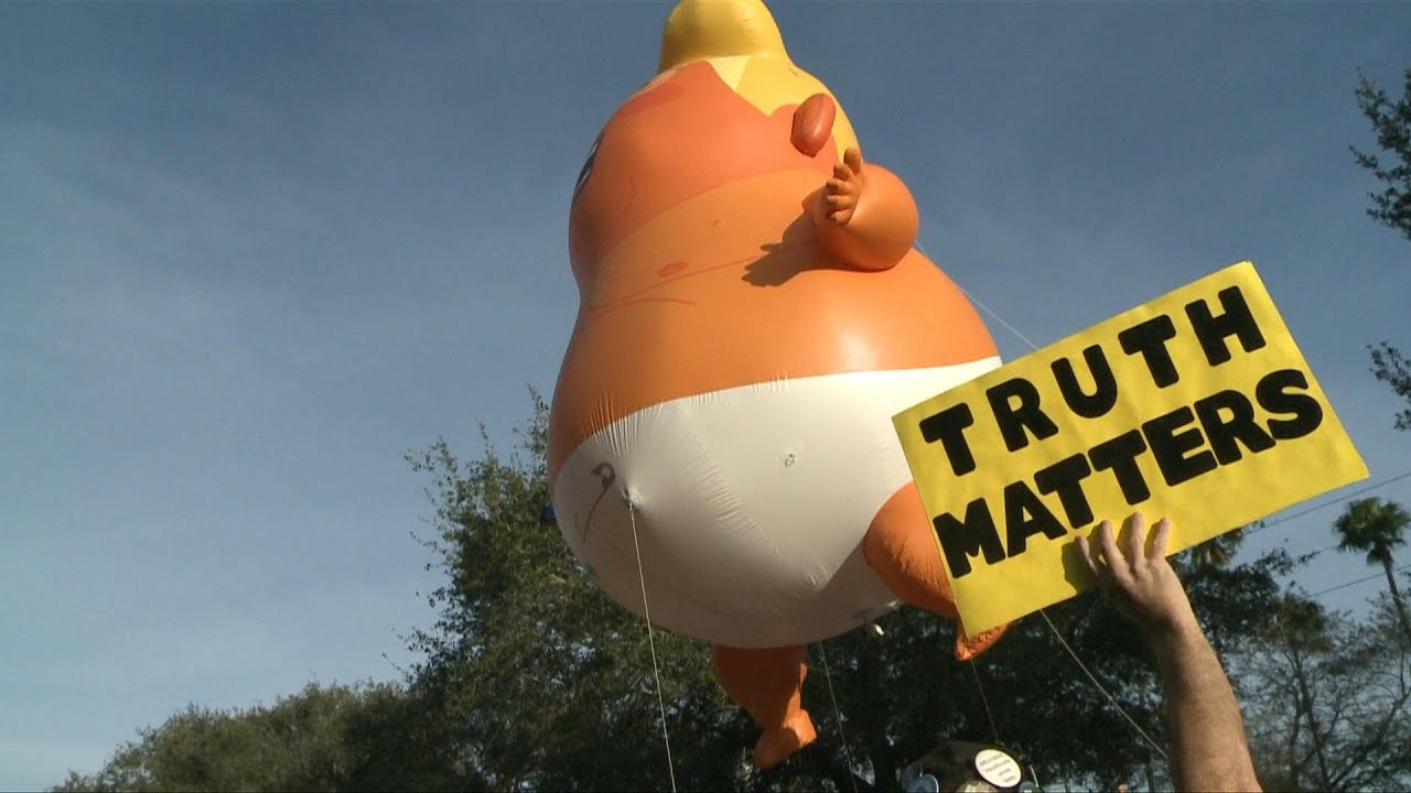 Inflatable 'baby Trump' balloon hoisted near rally | AFP
