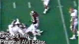 Celebrity Aaron Wallace holds up Andre Ware's helmet Profile