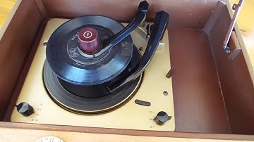 Magnavox Automatic record player playing a stack of 45
