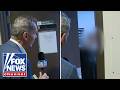 WATCH: Alleged hospice fraudster SLAMS DOOR on reporter