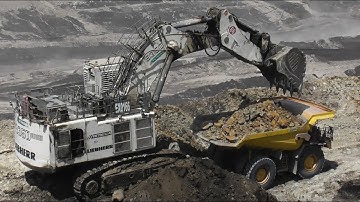 Liebherr R9350 Excavator Loading Komatsu And Caterpillar Dumpers - Coal Mining Operations