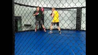 The Monster hitting pads with the A-Train at Des Moines MMA.