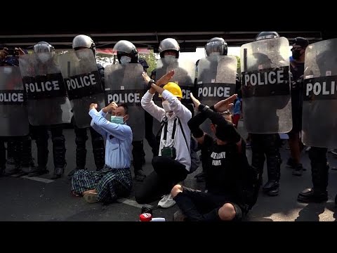 Officers in riot gear face off against protesters in Yangon