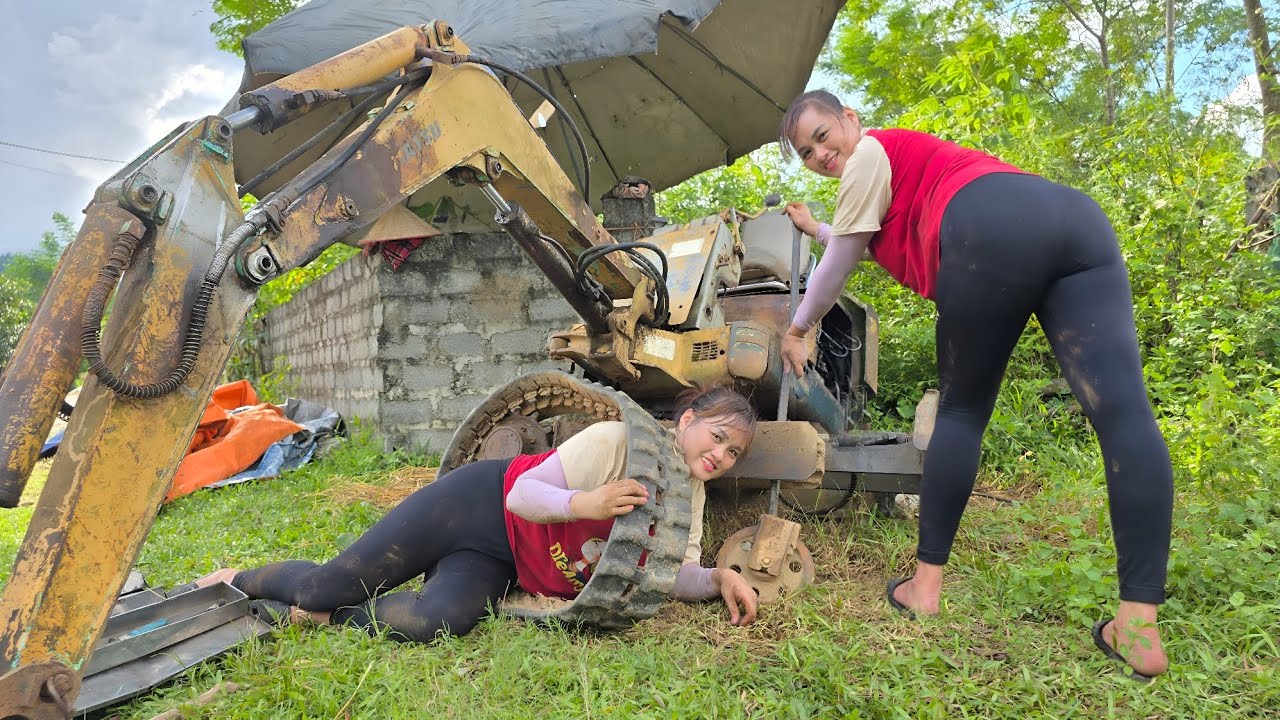 The girl repaired and maintained the old excavator was rusty and damaged many parts.