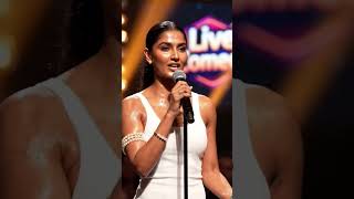 Background: bokeh audience, video wall with 'Live Comedy' graphics. 60fps, nat