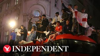 England fans climb on buses in London after Euros semi-final win