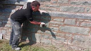 Finishing lime mortar off using a piece of wood, then a churn brush