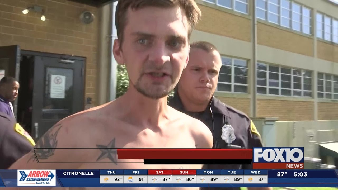 Stabbing suspect headbutts microphone on the way to jail