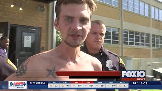 Stabbing suspect headbutts microphone on the way to jail