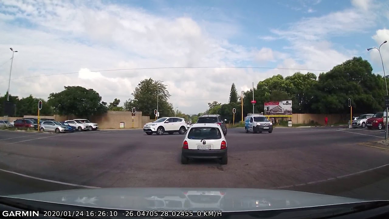 Driver Makes Illegal Turn through Red Traffic Light - YouTube
