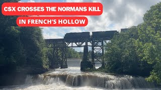 A backlit CSX locomotive crosses the Normans Kill in French's Hollow