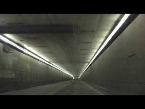 The Eisenhower Tunnel is a vehicular tunnel located at 39Â°40â²44â³N 105Â°55â²12â³Wï»¿ / ï»¿39.679Â°N 105.92Â°Wï»¿ / 39.679; -105.92 on Interstate 70 approximately 60 miles (97 km) west of Denver, Colorado. The tunnel was built under the Continental Divide, and at a maximum elevation of 11158 feet (3401 m) Above sea level, it is one of the highest vehicular tunnels in the world. It is also the longest tunnel built under the Interstate highway program and one of the last major pieces of the system to be completed. Its full official name is the Eisenhower-Johnson Memorial Tunnel (EJMT); the westbound bore is named after US President Dwight D. Eisenhower (for whom the Interstate system is also named), the eastbound bore after Edwin C. Johnson, a former governor and US Senator from Colorado. The tunnel is a two-bore tunnel with each bore approximately 1.7 miles (2.7 km) long. Construction of the westbound bore was started on March 15, 1968, and finished five years later on March 8, 1973. The eastbound bore was started on August 18, 1975, and completed over four years later on December 21, 1979. From 1973-79 the westbound bore carried a single lane of traffic in each direction. The total construction cost of the project was $108 million. In 2002, over ten million vehicles passed through the tunnel, many of them driving between the Denver area and popular skiing locations west of the Continental Divide. The eastern end of the tunnel is under and surrounded by the Loveland ski area. Trucks <b>...</b>