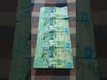 Четыре БАНКНОТЫ 2000 ТЕНГЕ на байковой поверхности 26-го Мая