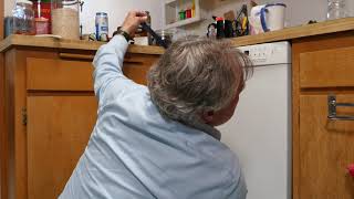 Removing a dishwasher for repair or replacement and disconnecting electric and water lines