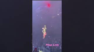 Mgk singing live while hanging from his tour helicopter