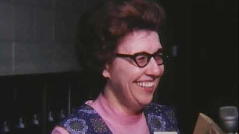 Moving library materials to new Bracken Library, 1975