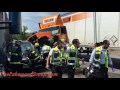 Vehicle pinned between tractor trailers