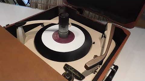 Silvertone record player playing  a few 45