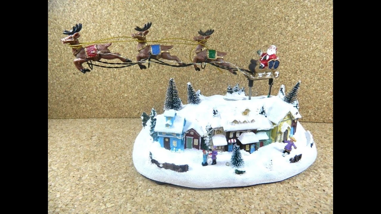 Villaggio Natalizio Slitta Babbo Natale Cm13x26x15h con Luci, Musica e