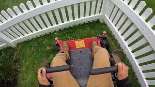 POV mowing a cookie cutter lawn