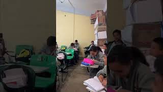 Wind Topples Stacked Boxes as Students Take Notes