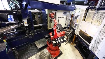 Comau NM 45 in aluminum die casting machine tending