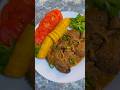 hígado de pollo guisado, acompañado de plátano hervido, tomate fresco y un toque rúcula