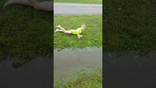 Playing in the ditch water.