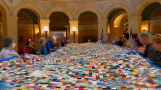 Activists unveil massive quilt to protest ICE