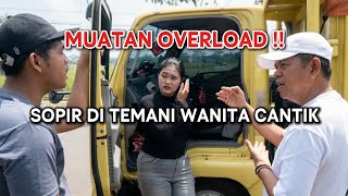 OVERLOAD!! THE TRUCK DRIVER IS ACCOMPANIED BY A BEAUTIFUL WOMAN.