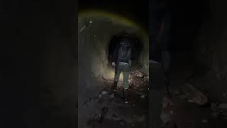 Exploring an abandoned mine tunnel.