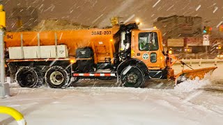 DSNY SALT SPREADER SPRAYING DURING WINTER STORM GAIL ON EAST 138TH STREET IN THE SOUTH BRONX, NYC.