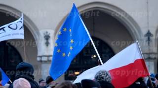 People waving flags of the EU and Poland