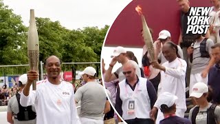 WATCH: Snoop Dogg carries Olympic torch ahead of 2024 Opening Ceremony