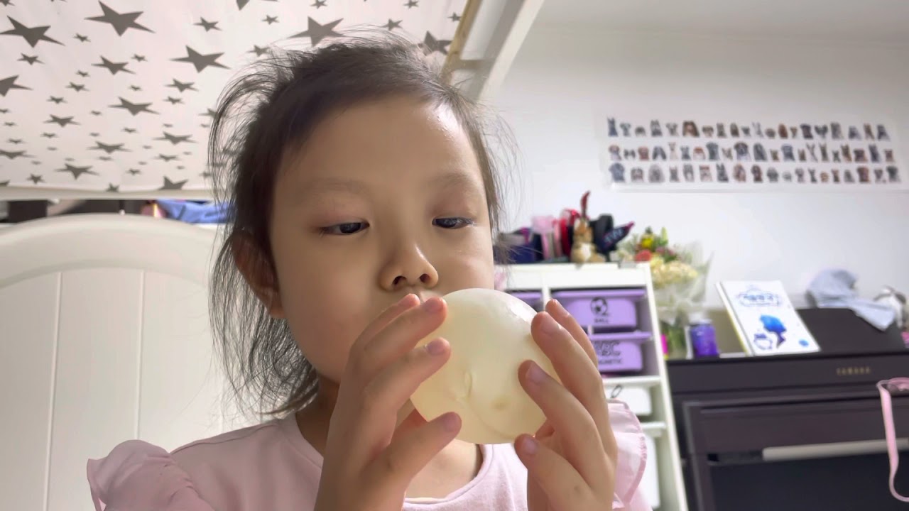 Blowing the rubber balloon bigger than my face